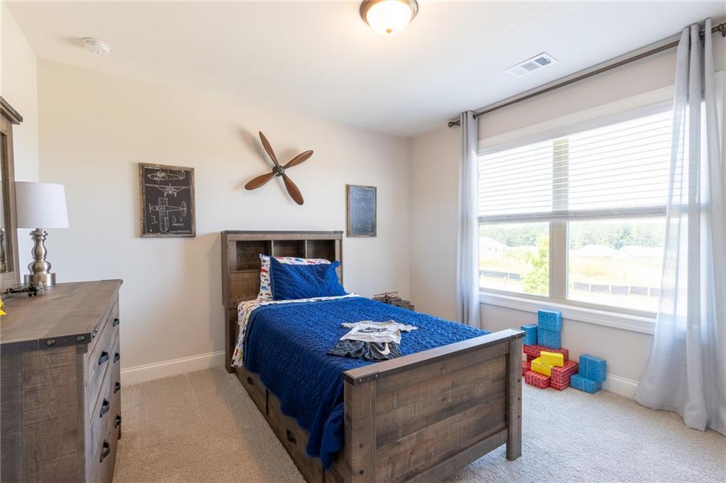 560 Calgary Downs Drive Winder, GA 30680 - Photo 37 of 37 a bedroom with a bed and a desk