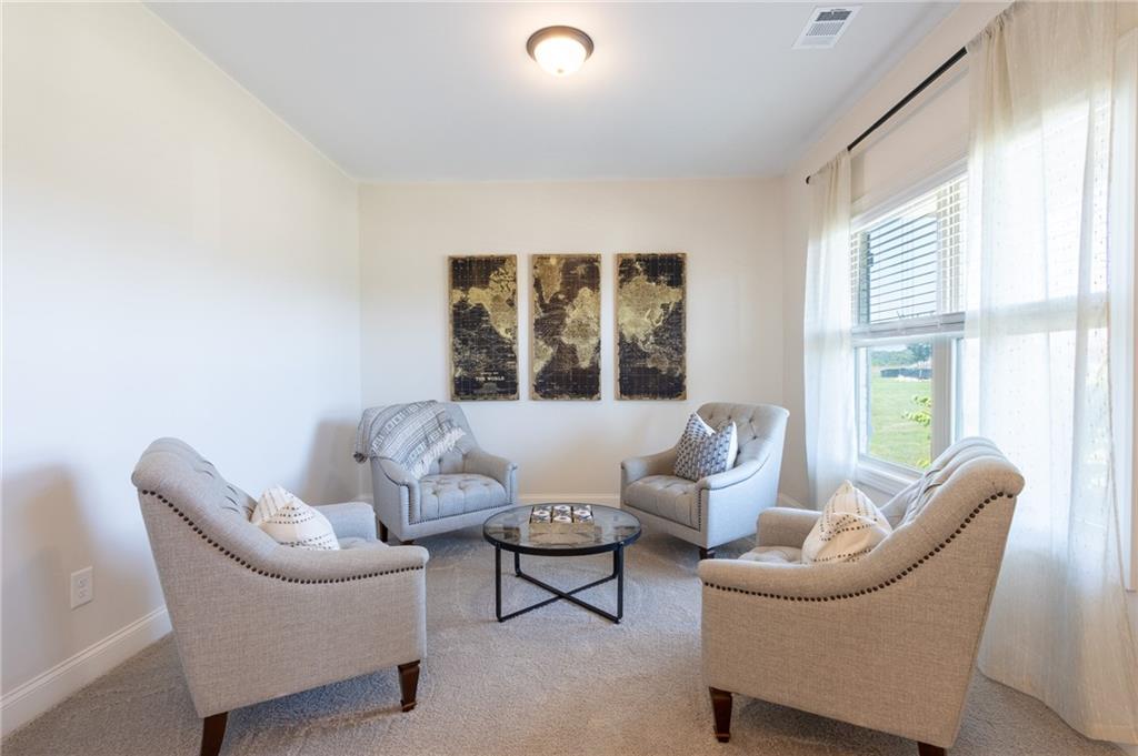 560 Calgary Downs Drive Winder, GA 30680 - Photo 10 of 37 a living room with furniture and a large window