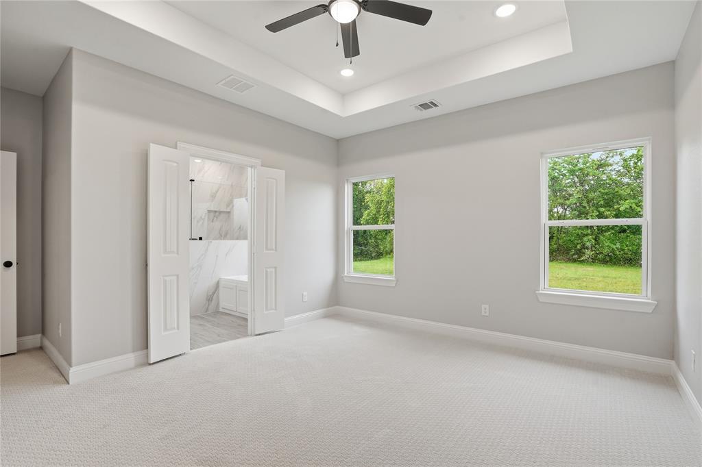 420 Ball Street Tom Bean, TX 75491 - Photo 12 of 34 an empty room with windows and a chandelier fan