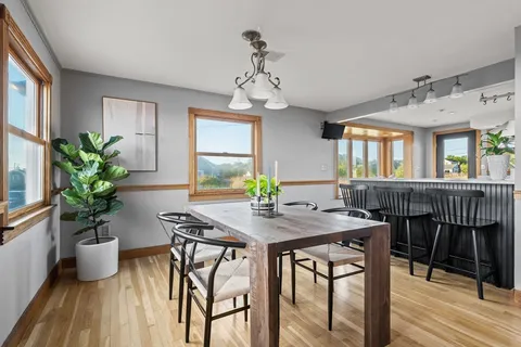 a view of a dining room with furniture window and wooden floor