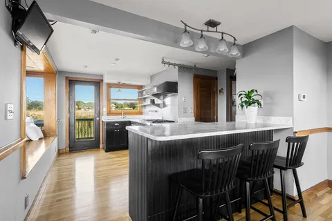 a kitchen with stainless steel appliances granite countertop a stove and a refrigerator