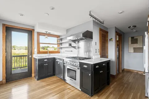 a large kitchen with stainless steel appliances granite countertop a lot of counter space