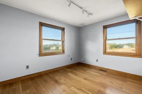 a bathroom with a sink toilet and window