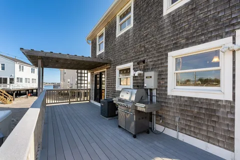 a view of a terrace with lawn chairs