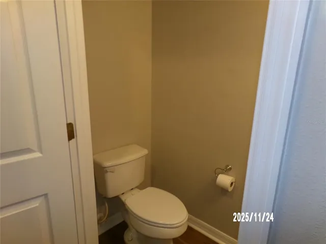 a white toilet sitting next to a shower in a bathroom