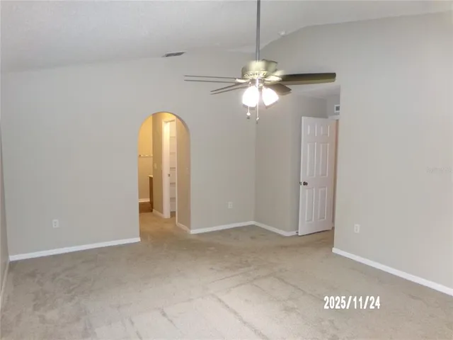 a view of a chandelier fan and entryway
