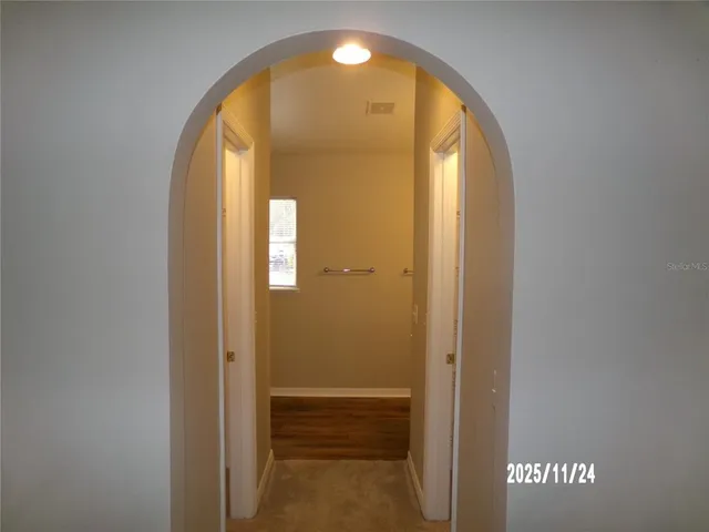 a view of a hallway with wooden door
