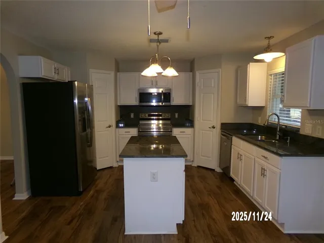 a kitchen with a stove and a refrigerator