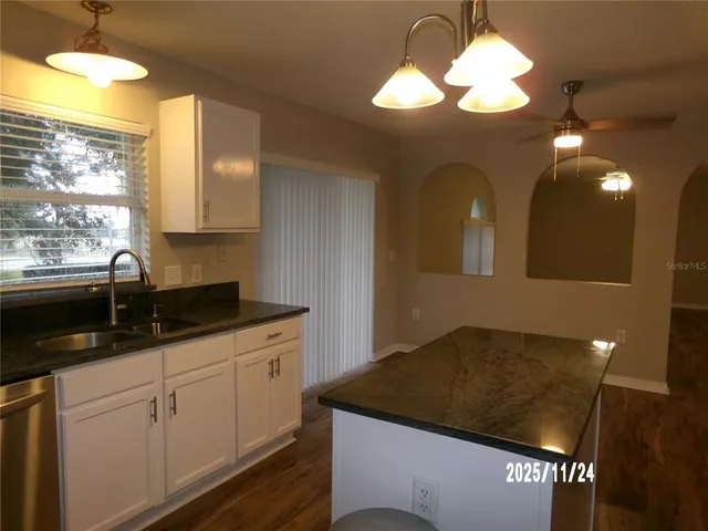 a kitchen with a sink a counter space and a window