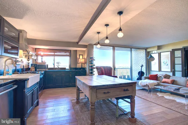 a room with granite countertop lots of wooden furniture