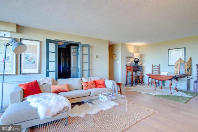a living room with furniture a rug and a table