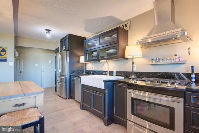 a kitchen with stainless steel appliances granite countertop a stove and a refrigerator