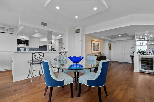 a large white kitchen with stainless steel appliances a lot of counter space and a sink