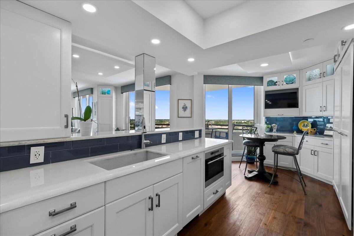 3322 Casseekey Island Road, Unit 901 Jupiter, FL 33477 - Photo 14 of 68 a large white kitchen with stainless steel appliances a lot of counter space and a sink