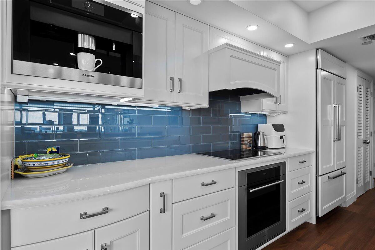 3322 Casseekey Island Road, Unit 901 Jupiter, FL 33477 - Photo 17 of 68 a kitchen with stainless steel appliances granite countertop a sink a stove and cabinets