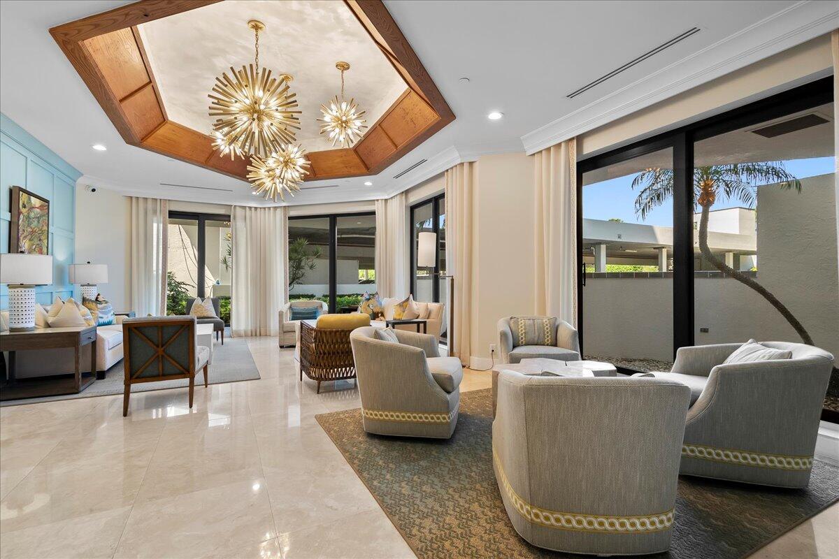 3322 Casseekey Island Road, Unit 901 Jupiter, FL 33477 - Photo 41 of 68 a living room with furniture a chandelier and a large window