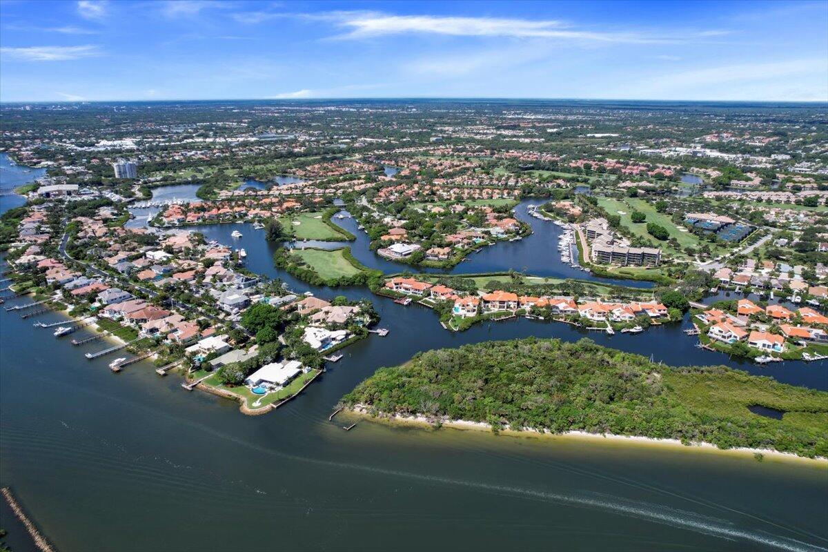 3322 Casseekey Island Road, Unit 901 Jupiter, FL 33477 - Photo 65 of 68 an aerial view of a city with lots of residential buildings ocean and mountain view in back