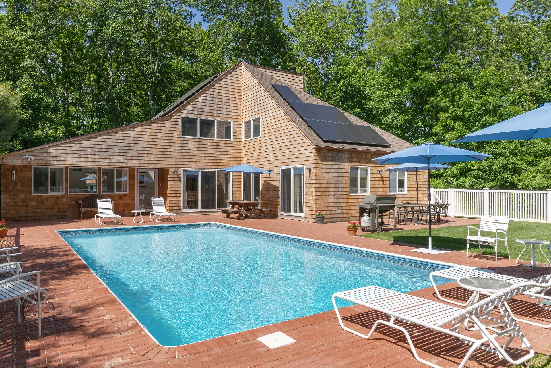 a view of a house with a yard patio and swimming pool