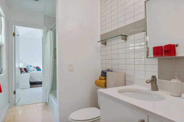 a bathroom with a sink toilet and shower