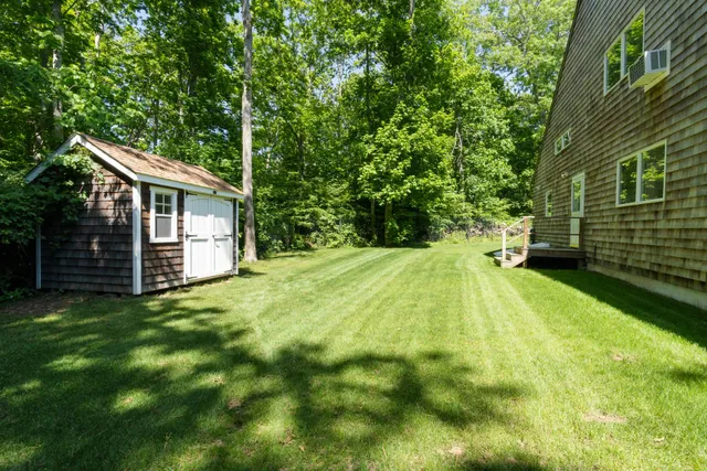 a view of a house with a backyard