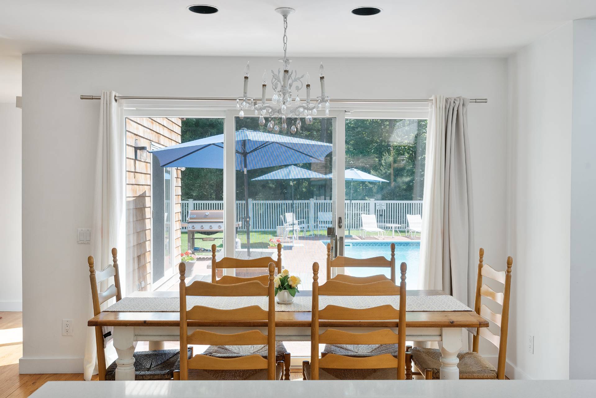 11 Wagon Lane East Hampton, NY 11937 - Photo 6 of 17 a view of a dining room with furniture wooden floor and chandelier
