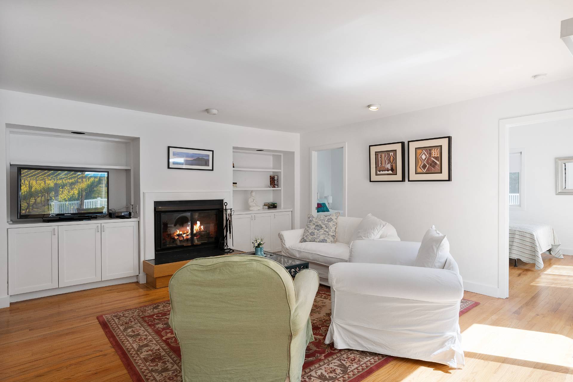 11 Wagon Lane East Hampton, NY 11937 - Photo 8 of 17 a living room with furniture a flat screen tv and a fireplace