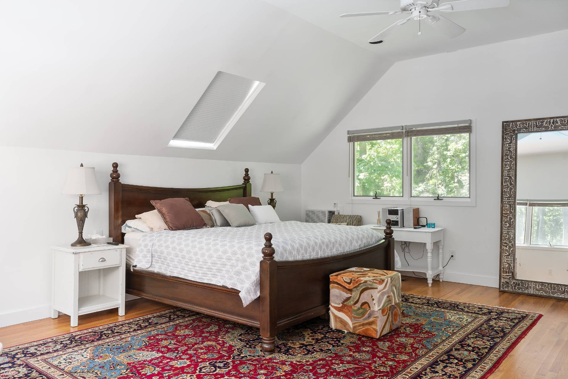 11 Wagon Lane East Hampton, NY 11937 - Photo 9 of 17 a bedroom with a bed and a chandelier