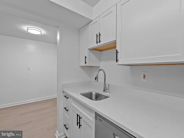 a kitchen with a sink and cabinets