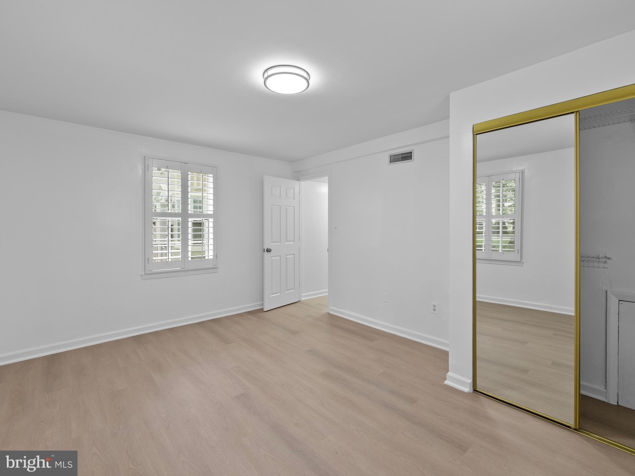 708 South Arlington Mill Drive, Unit 104 Arlington, VA 22204 - Photo 16 of 24 an empty room with windows