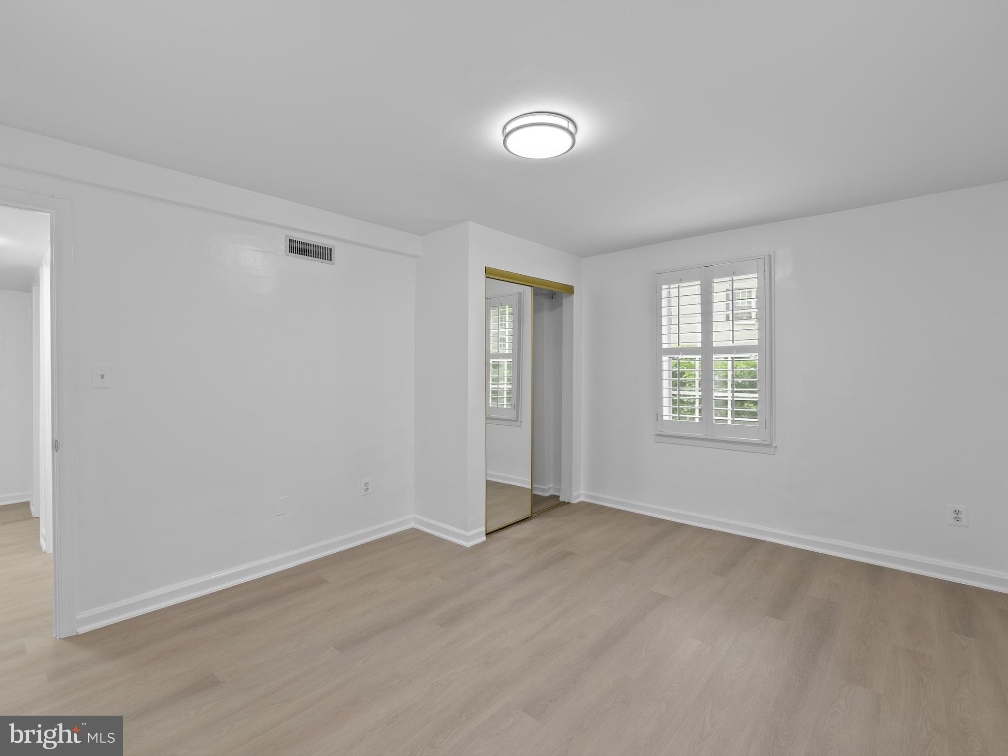 708 South Arlington Mill Drive, Unit 104 Arlington, VA 22204 - Photo 5 of 24 an empty room with windows