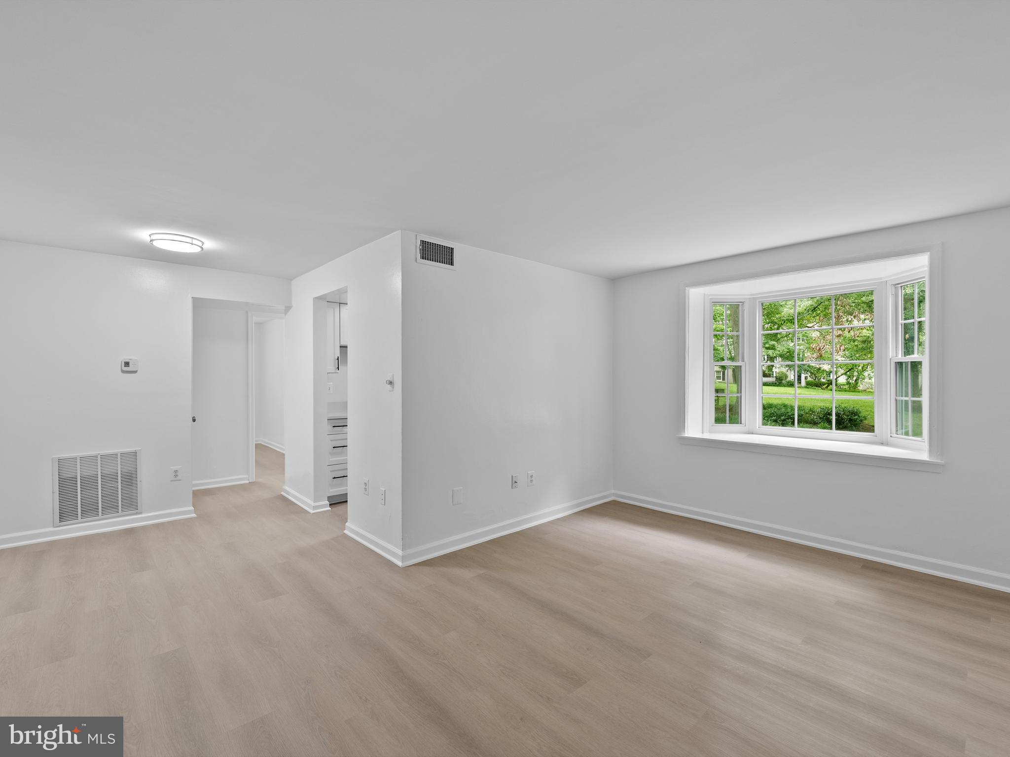 708 South Arlington Mill Drive, Unit 104 Arlington, VA 22204 - Photo 8 of 24 a view of an empty room with a window