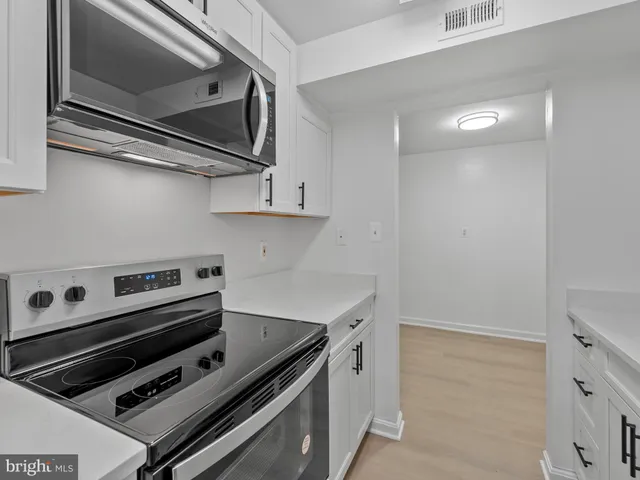 a kitchen with a stove and a microwave