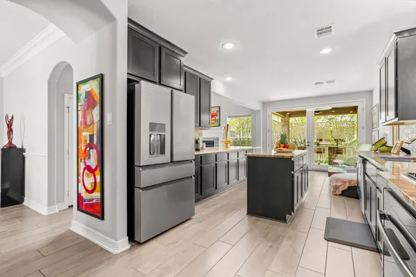 a kitchen with a sink stove and cabinets