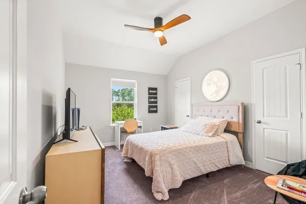 a bedroom with a bed and a window