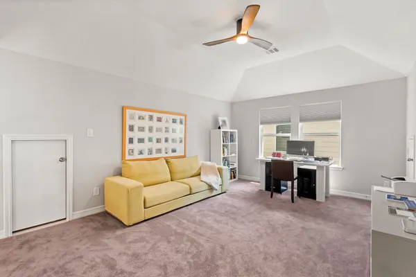 a bedroom with furniture and a book shelf