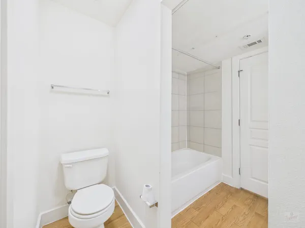 a bathroom with a toilet and bathtub