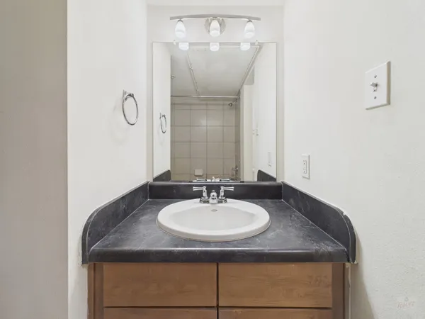 a sink sitting next to a bathroom sink