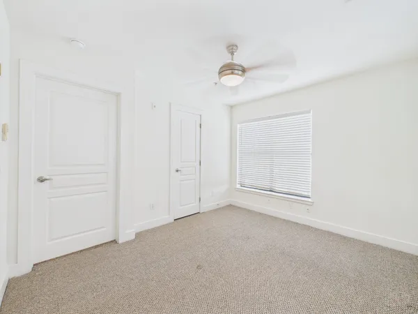 an empty room with a empty space and a ceiling fan