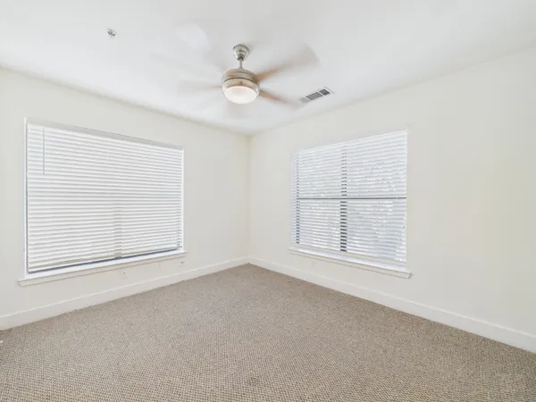 an empty room with a empty space and windows