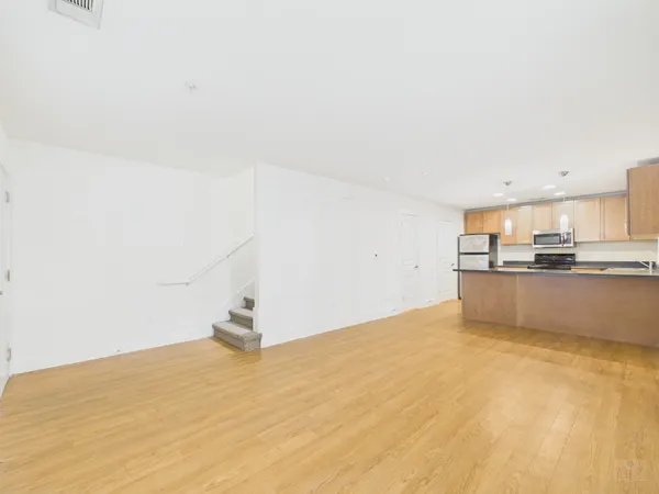 a view of a kitchen with microwave and cabinets