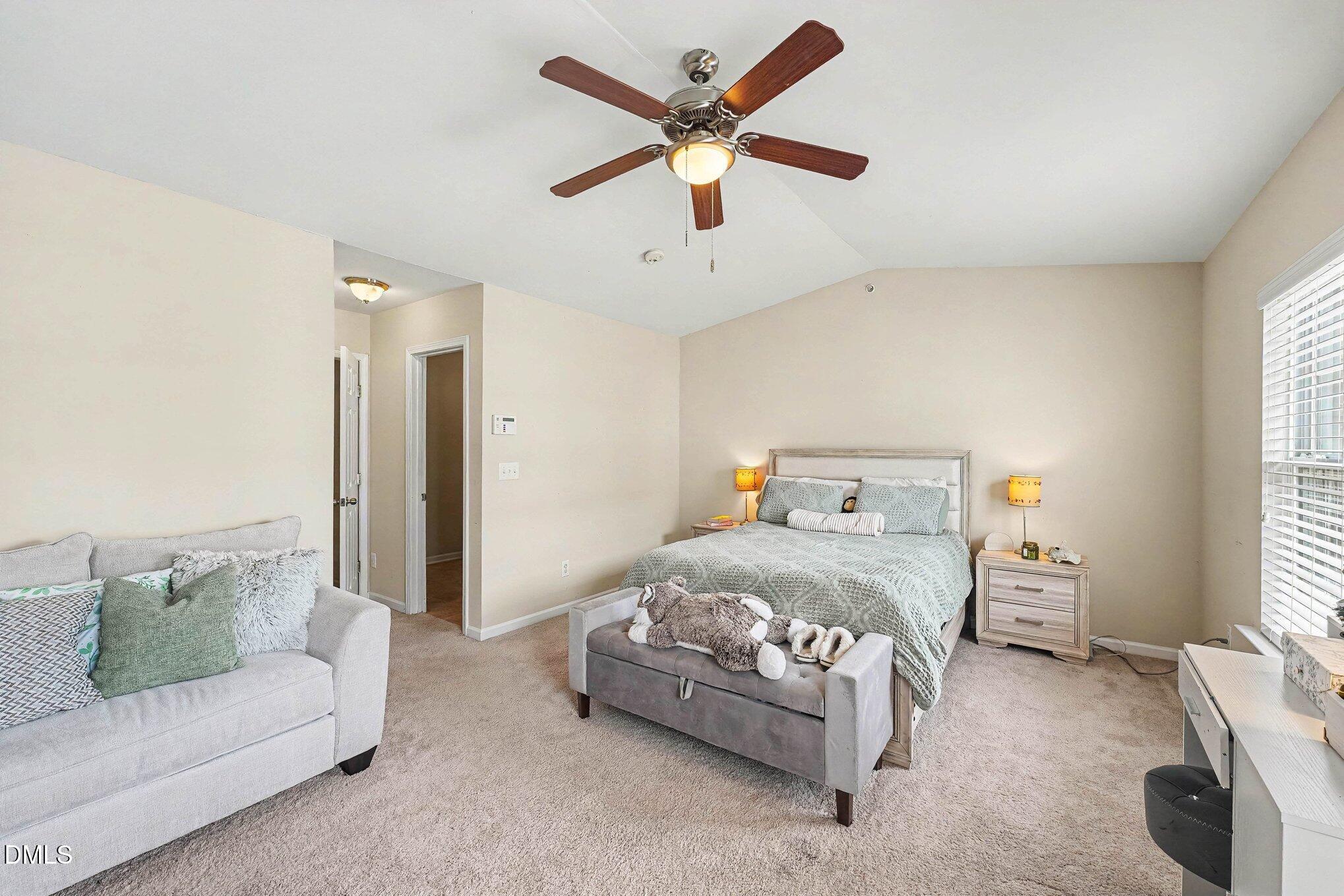 1130 Renewal Place, Unit 106 Raleigh, NC 27603 - Photo 19 of 34 a bedroom with a bed couches and window