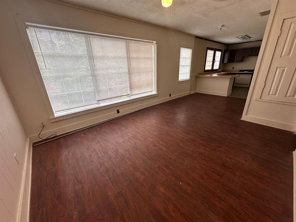 342 Prospect Street Shreveport, LA 71104 - Photo 2 of 8 an empty room with wooden floor and windows