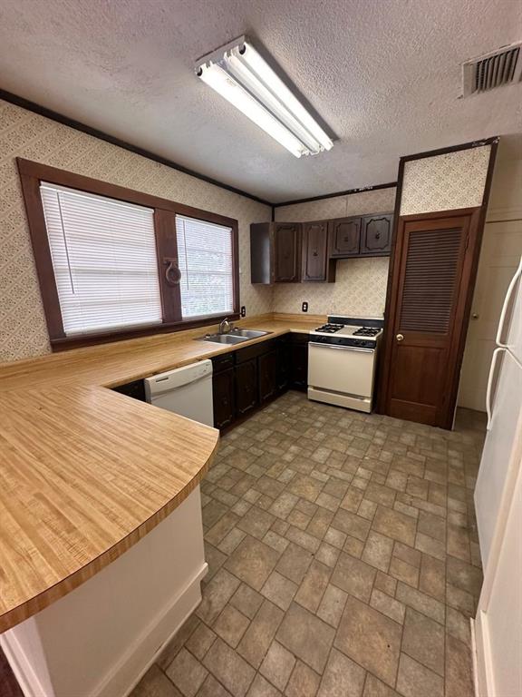 342 Prospect Street Shreveport, LA 71104 - Photo 4 of 8 a large kitchen with stainless steel appliances granite countertop a sink stove and refrigerator