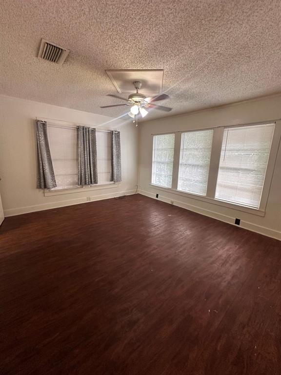 342 Prospect Street Shreveport, LA 71104 - Photo 5 of 8 a view of an empty room with a window and wooden floor