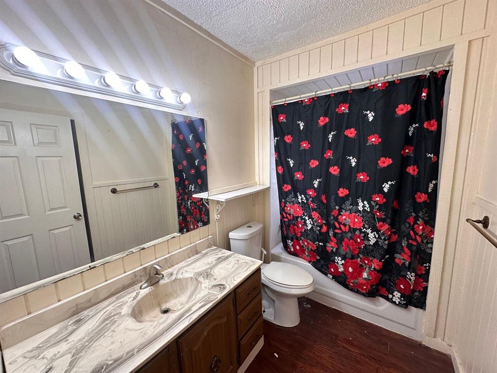 342 Prospect Street Shreveport, LA 71104 - Photo 6 of 8 a bathroom with a sink vanity mirror and toilet
