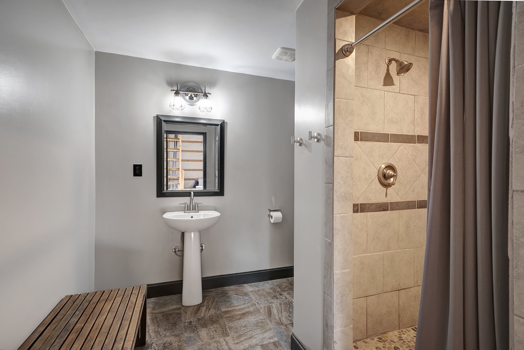 3155 Pigeon Spur Road South Pittsburg, TN 37380 - Photo 67 of 78 a bathroom with a sink a mirror and shower