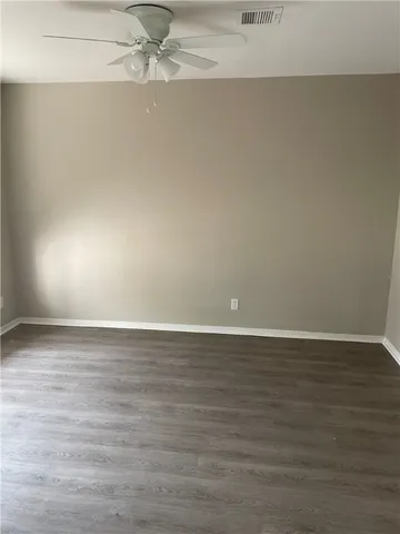 a view of an empty room and wooden floor