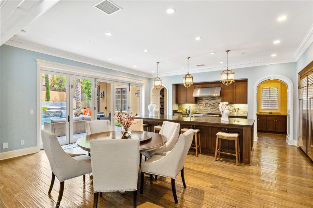 121 Treasure Irvine, CA 92602 - Photo 14 of 41 a dining room with wooden floor and furniture