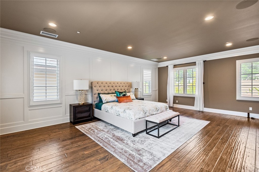 121 Treasure Irvine, CA 92602 - Photo 26 of 41 a spacious bedroom with a large bed rug and wooden floor