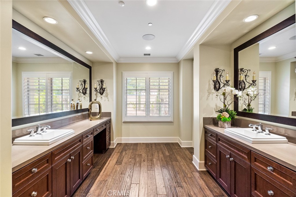 121 Treasure Irvine, CA 92602 - Photo 27 of 41 a spacious bathroom with a granite countertop double vanity sink a large mirror and a bathtub